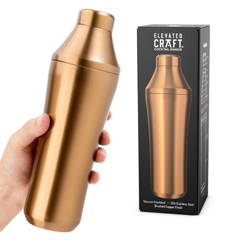 A hand holding a copper cocktail shaker next to its box
